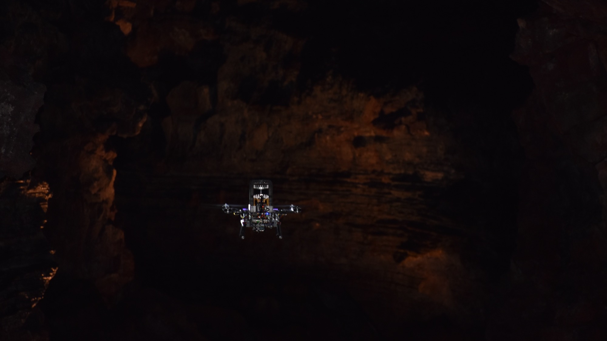 The exploration drone hovering inside the dark lava tube